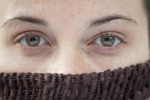 woman face with nose covered by sweater